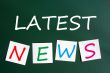 Chalk drawing of Latest news on sticky notes and green chalkboar