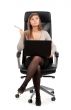 Young business lady in a chair with a laptop