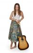 girl stands with acoustic guitar