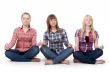 Three girls sitting in lotus posture