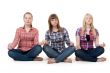 Three girls sitting in lotus posture