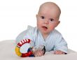 infant with colored plastic toy