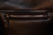 Zipper on dark brown leather hand bag