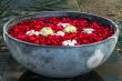 Rose petals, lotos and plumeria flowers in the bowl