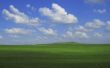 Green field and blue sky and white clouds