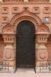 wall of red brick and black front door