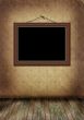 frame hangs on an old wall. 