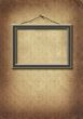 frame hangs on an old wall