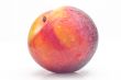 Bright ripe plum on a white background