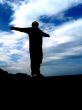 Man Standing On The Edge Of The World