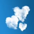 three heart-shaped clouds on blue sky 