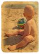 The child sits on the sand. Old postcard.