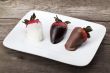  coated strawberries on a white plate