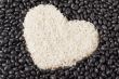 heart shape rice grains isolated on the dark beans