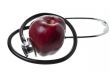 apple and stethoscope on white background