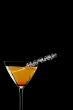 close up shot of orange drink in martini glass
