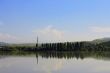 Calm lake and low mountains behind it