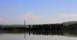 Calm lake and low mountains behind it