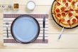 top view of table utensil  and pizza