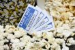 spilled popcorn with movie tickets
