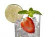 cropped image of a glass with ice cubes strawberry slice and lemon slice