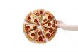 hand lifting a slice of pepperoni pizza