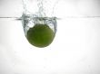 fresh lime falling into water