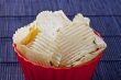 fried potato chips in red plastic bowl
