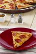 pepperoni pizza with salt and pepper shaker