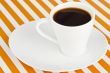a mug of dark coffee on a saucer
