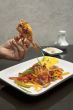 human hands and crab dish