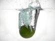 fresh lime splashing in water