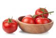 tomatoes in a wooden bowl isolated on white background