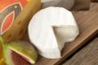 slice cheese and fig on wooden board