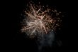fireworks explode into a ball of sparks