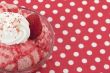 strawberry ice cream with toppings on the bowl