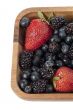 strawberries blueberries and blackberries in wooden bowl