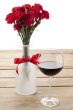red peony and wine glass decorated in wooden table