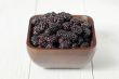 pile of blackberries on wooden bowl
