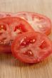 slices of fresh tomatoes on the wooden table