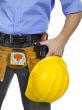 a worker with yellow helmet and construction tools 