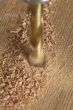 cropped image of drilling a hole in peace of wood