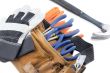 close up shot of tool belt with wrench and hand gloves