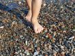 Barefoot child on the wet beach