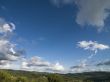 blue sky with grey clouds with tuscan landscape