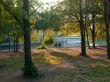 view of two people sitting on bench beside lake