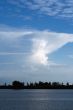 view of calm sea with clouds in background