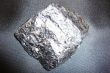 Silvery shiny stone on a black background.