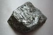 Silvery shiny stone on gray background.