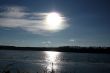 Lake and sky with sun.